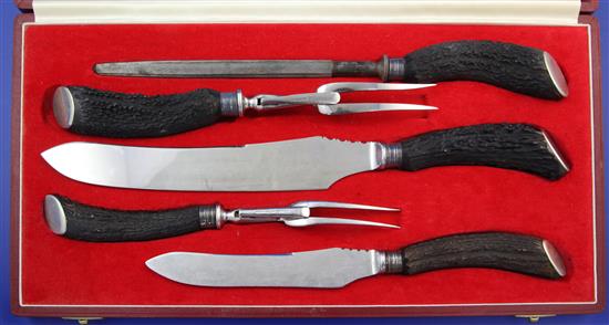 A modern cased five piece stag horn handled carving set by Asprey & Co Ltd & set of steak knives.